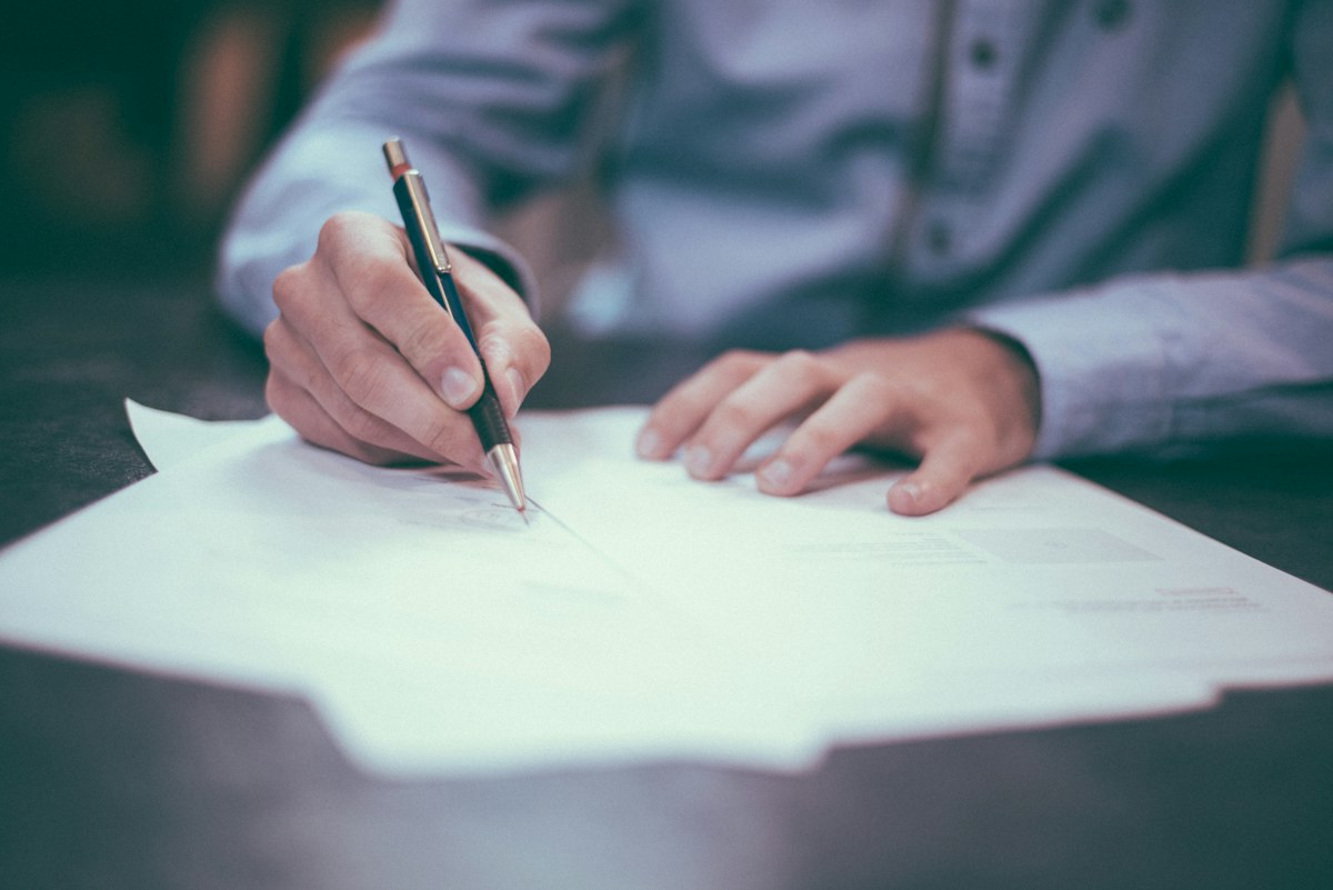 Contract being signed with a pen
